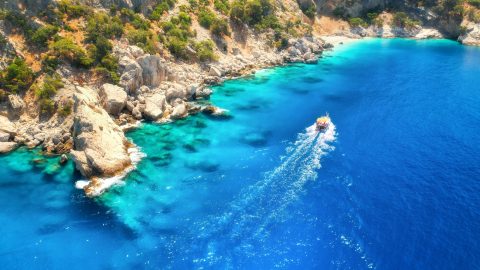 speed-boat-in-blue-sea-at-sunrise-in-summer-aerial-view.jpg